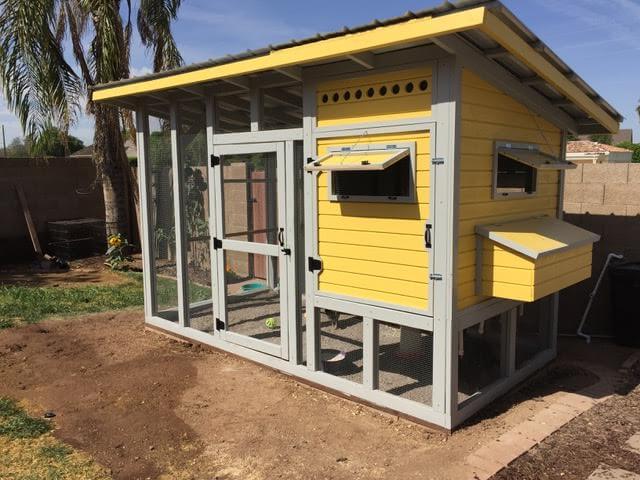 JW1 Chicken coop built from these plans. It's painted a sunny yellow color with grey trim. It looks very nice on a sunny day.