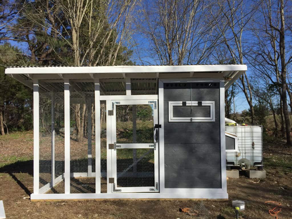 image1 A version of the coop plans built on cinder blocks and painted dark grey with white trim.